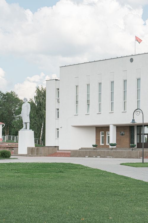 Free A stylish urban shot of an elegant modern building and statue in Myadel, Belarus. Stock Photo