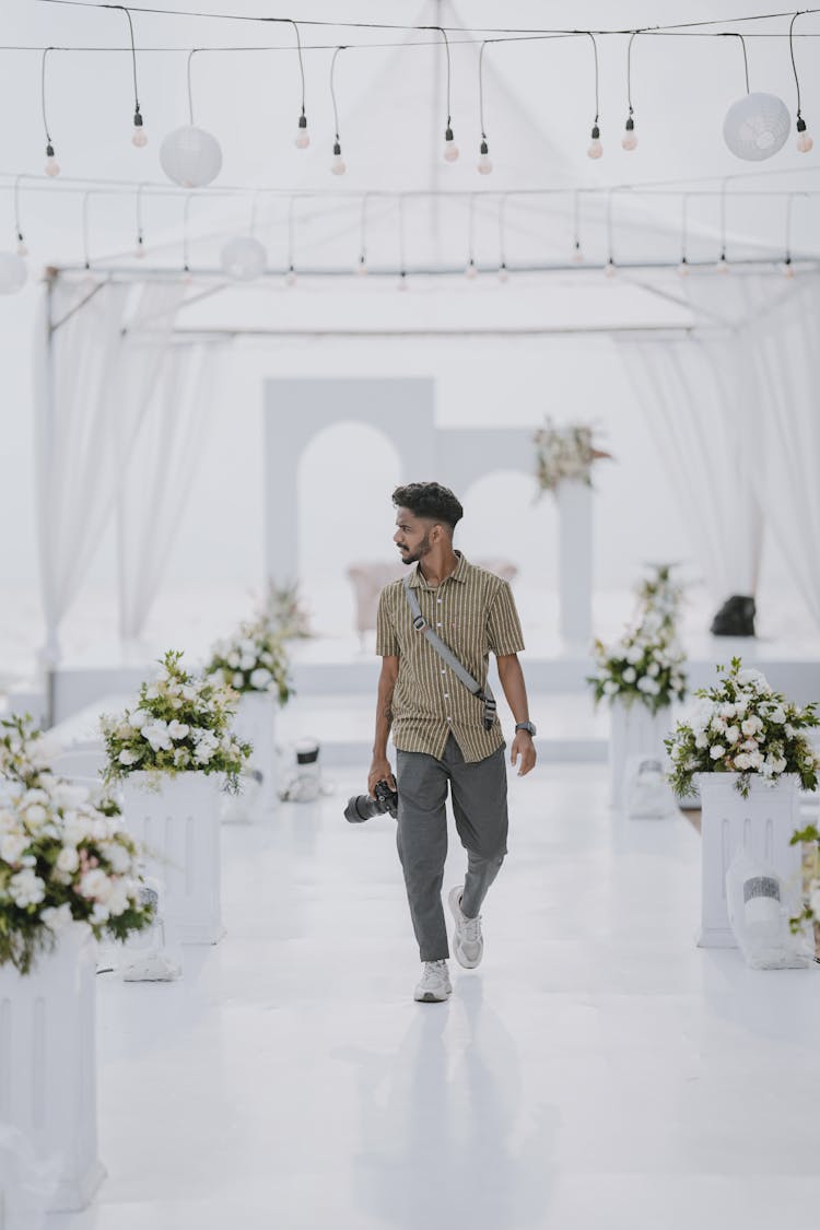 Photographer Walking Through Wedding Venue 