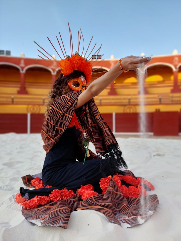 Woman In Carnival Mask Pouring Sand