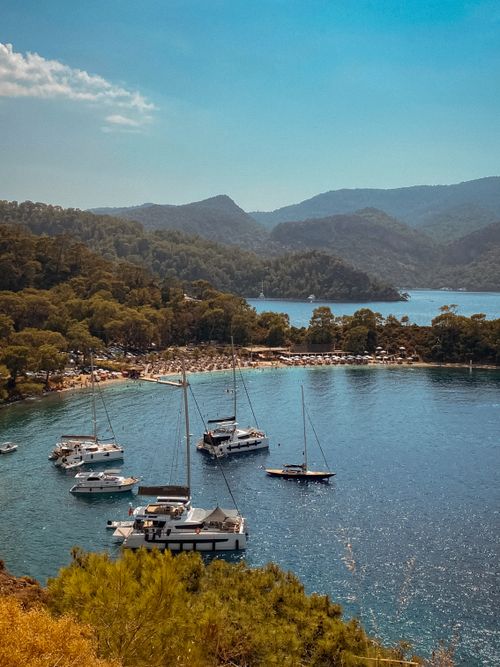 Free A breathtaking aerial view of boats anchored in Fethiye's serene bay surrounded by lush forests. Stock Photo