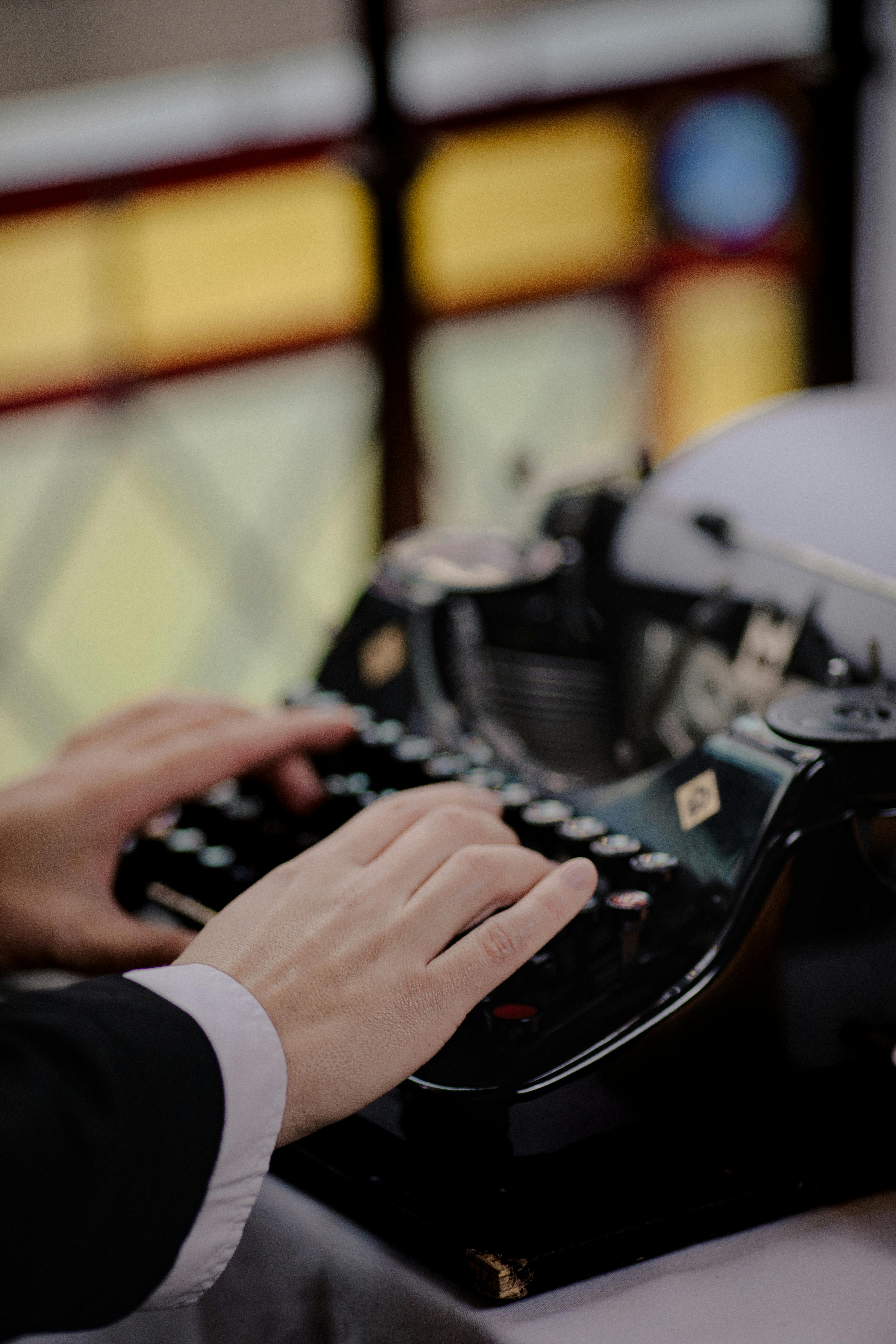 close up of a person writing on a typewriter