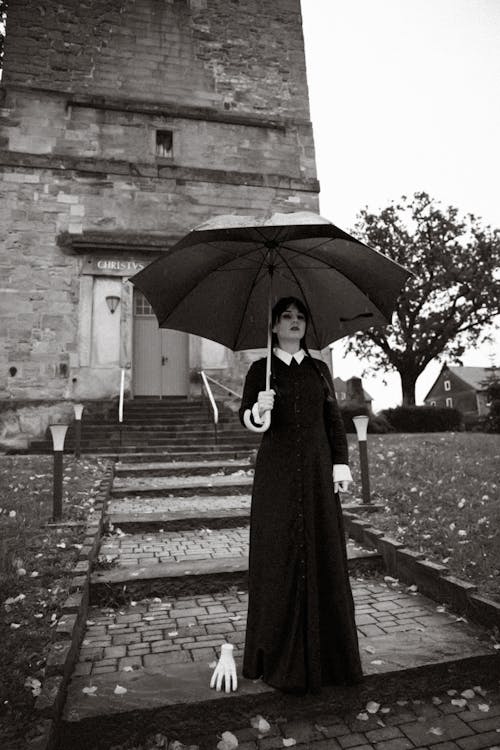 Woman in Wednesday Addams Costume with Thing in Autumn