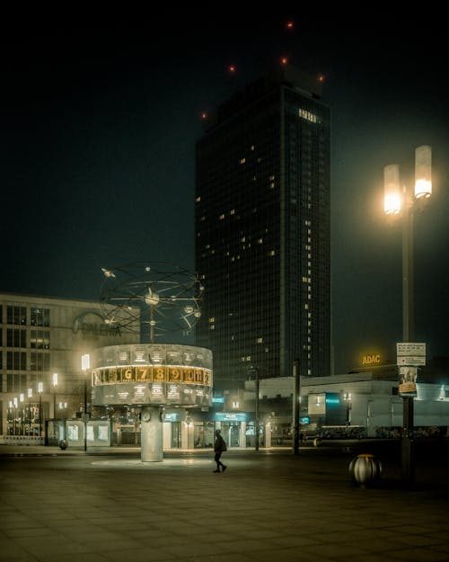 Man Walking on an Empty Lot in the City at Night