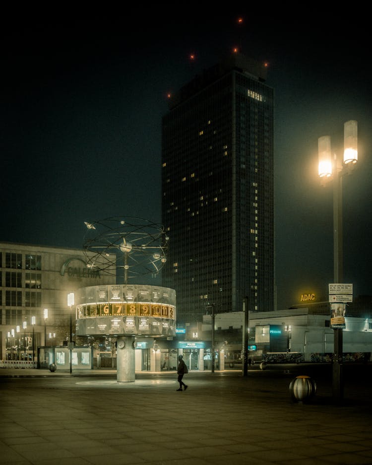 Man Walking On An Empty Lot In The City At Night