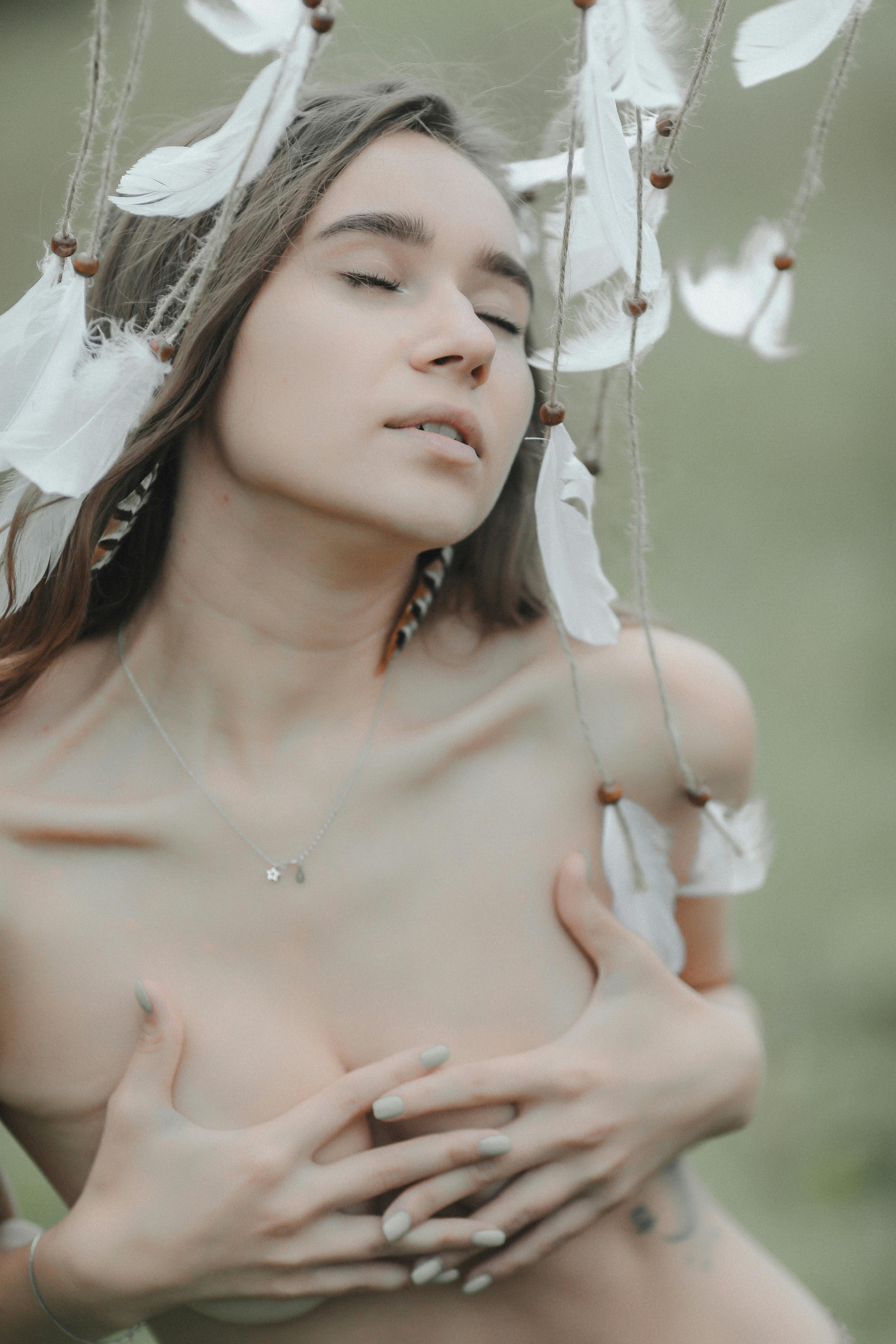 Peaceful woman in serene meditative pose, eyes closed, soft natural light implying deep hypnotic calm