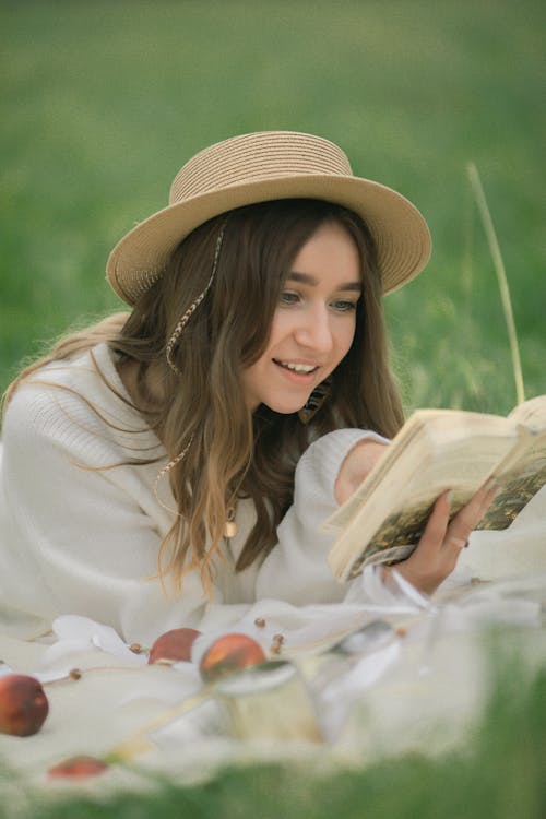 Portrait of Woman Reading a Book on a Field 