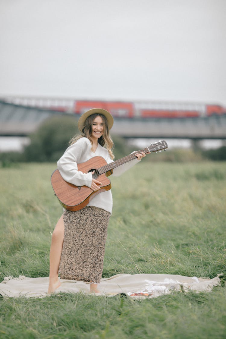 Young Woman Playing The Guitar