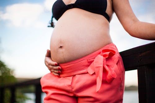 Woman Holding a Hand on her Pregnant Belly