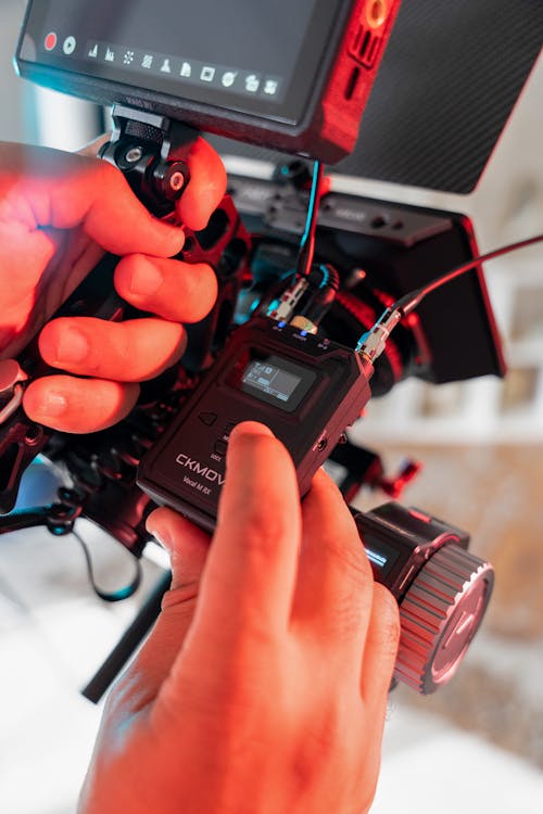 Hands of a Man Operating the Camera Equipment