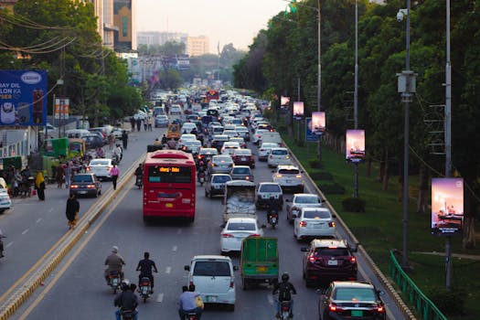 A bustling city road in Punjab, Pakistan, showcasing heavy traffic during the day.