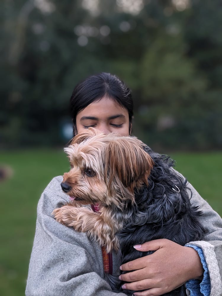 A Woman Holding A Dog