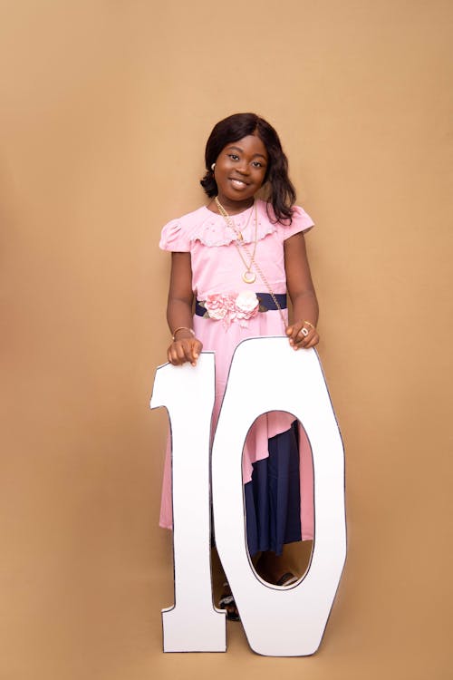 A Girl in a Pink Dress with a Number 10
