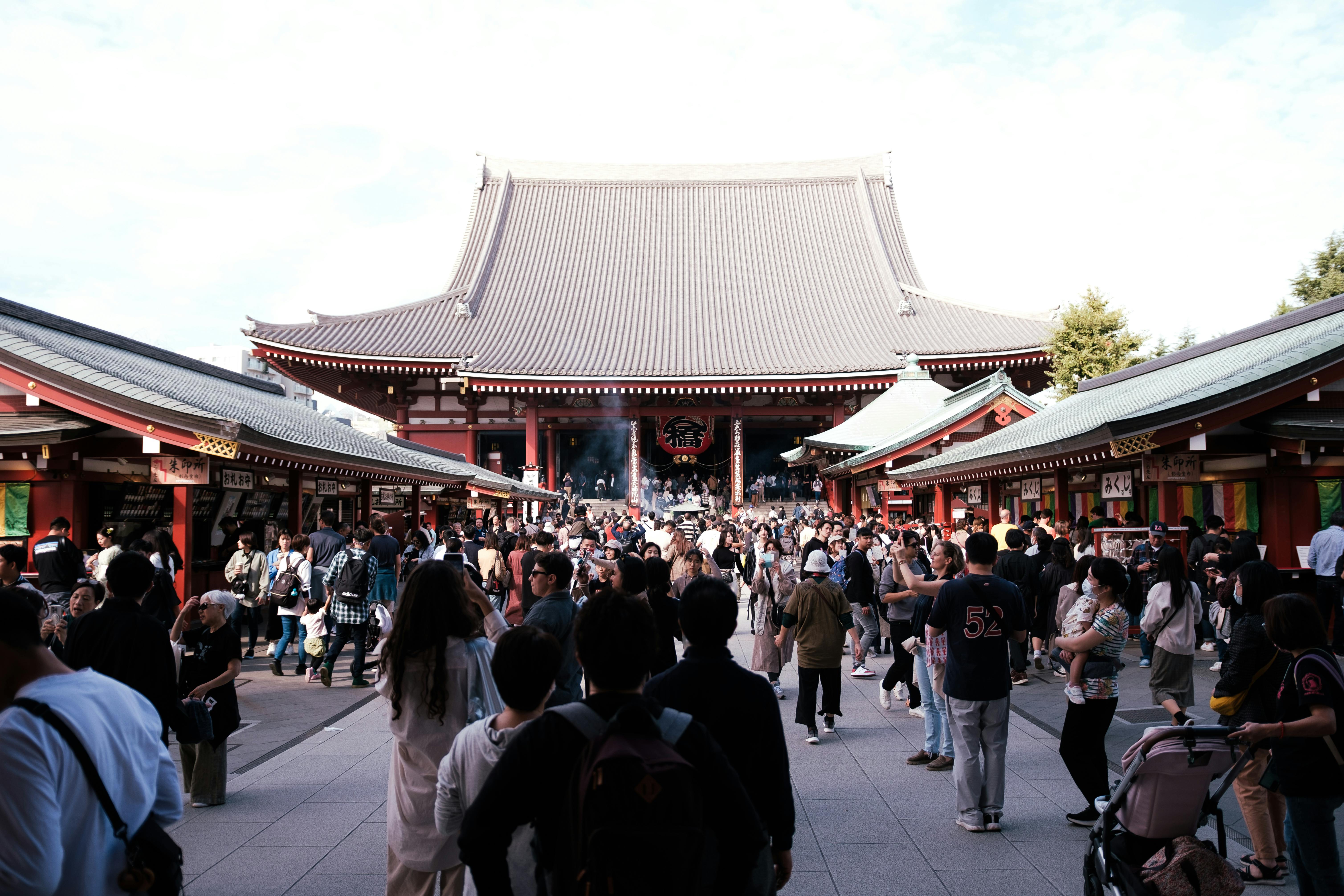 Crowds gather at the iconic Senso-ji Temple in Tokyo, Japan, capturing cultural and urban life.