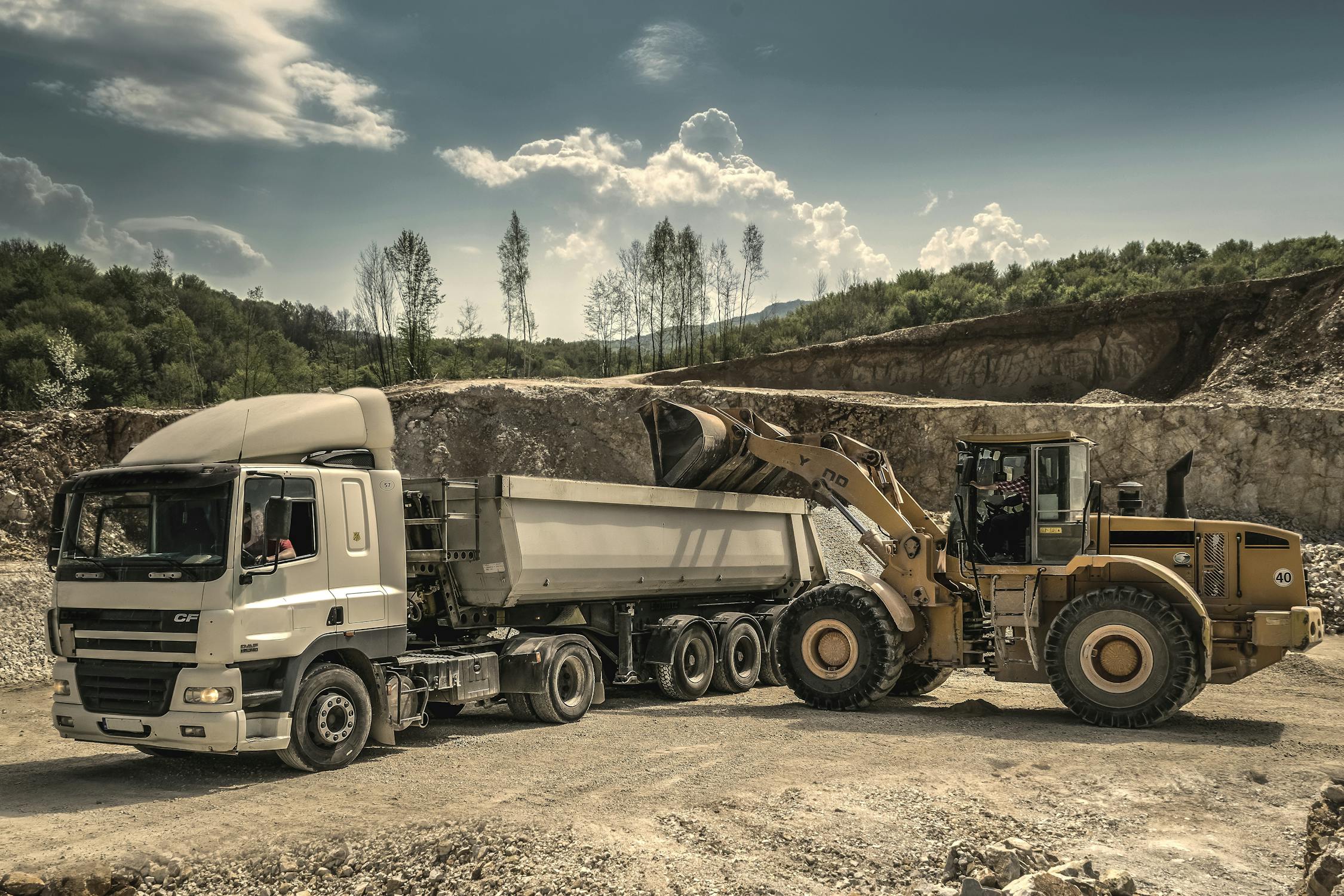 Truck loads clay for brick making.