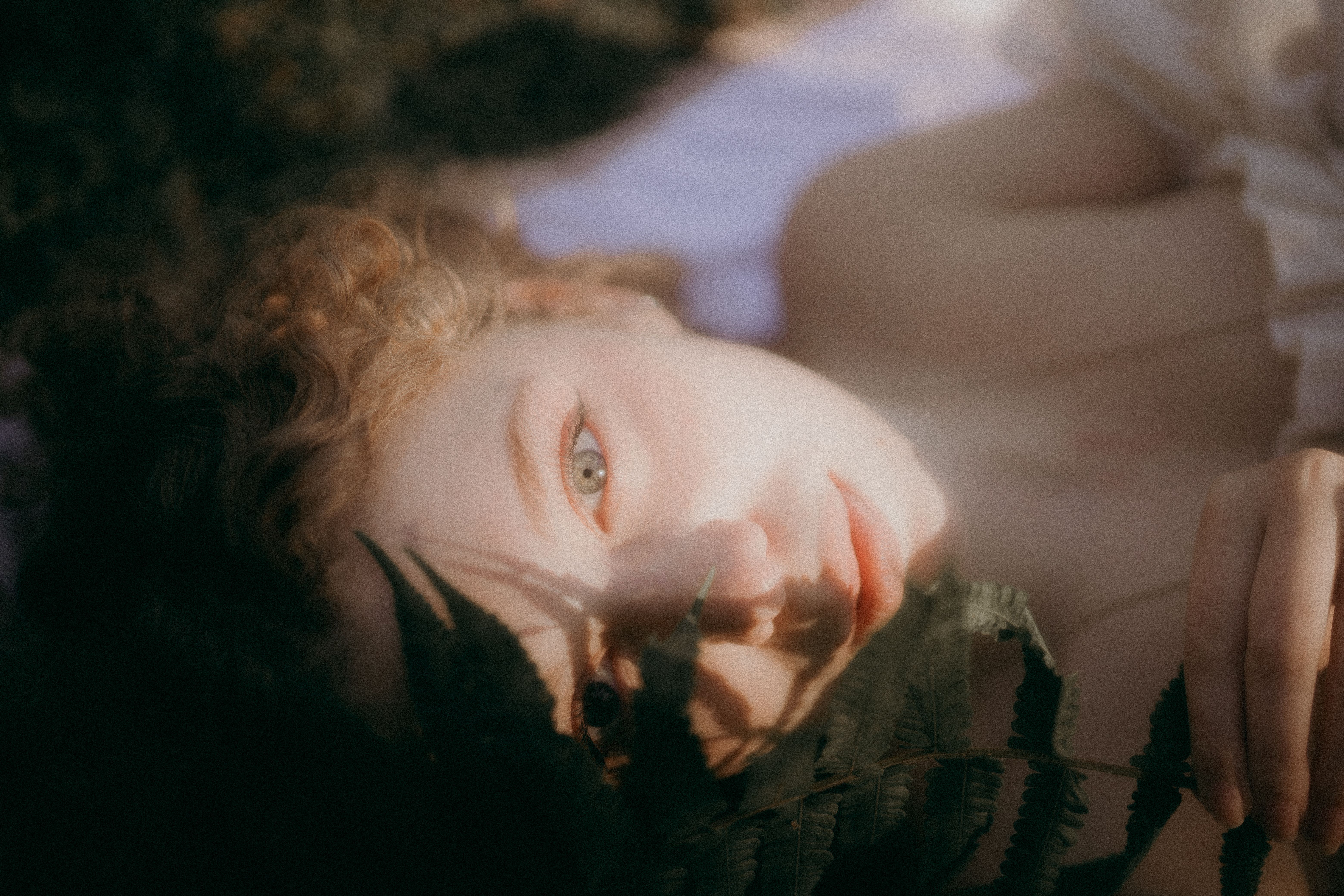 Portrait of a Young Woman Holding a Fern Leaf · Free Stock Photo