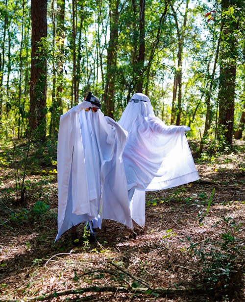 People Wearing Sheet in a Forest