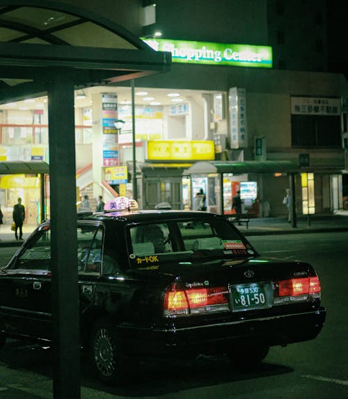 Black Toyota Crown Taxi at Night