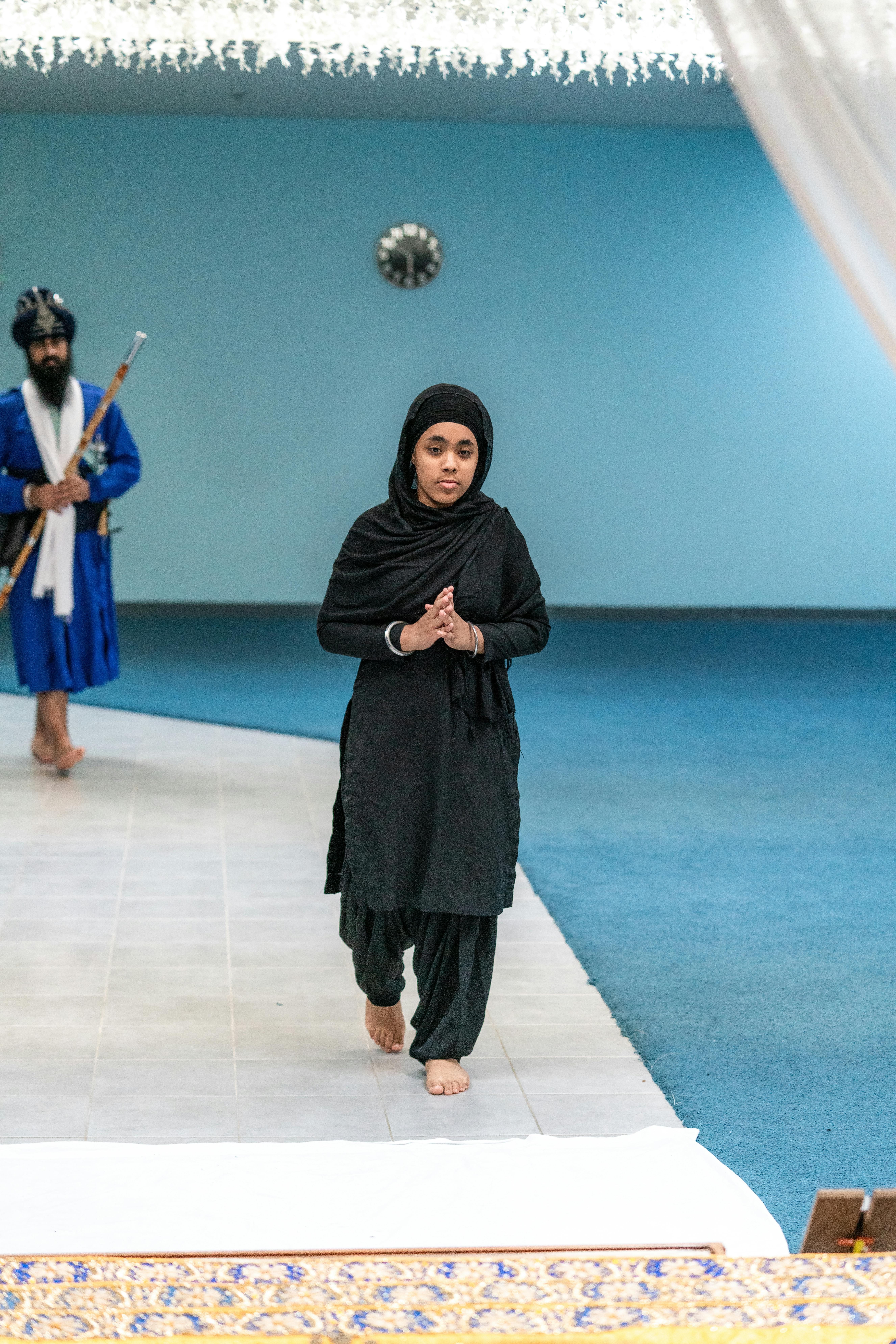 Young Woman Praying Barefoot in a Mosque · Free Stock Photo