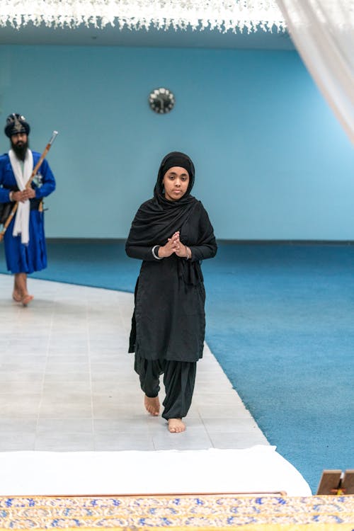 Young Woman Praying Barefoot in a Mosque · Free Stock Photo