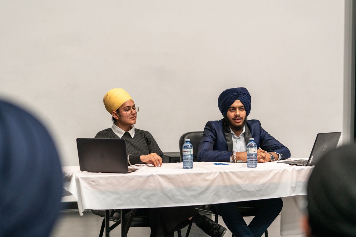 Two professionals in a focused discussion at a conference table