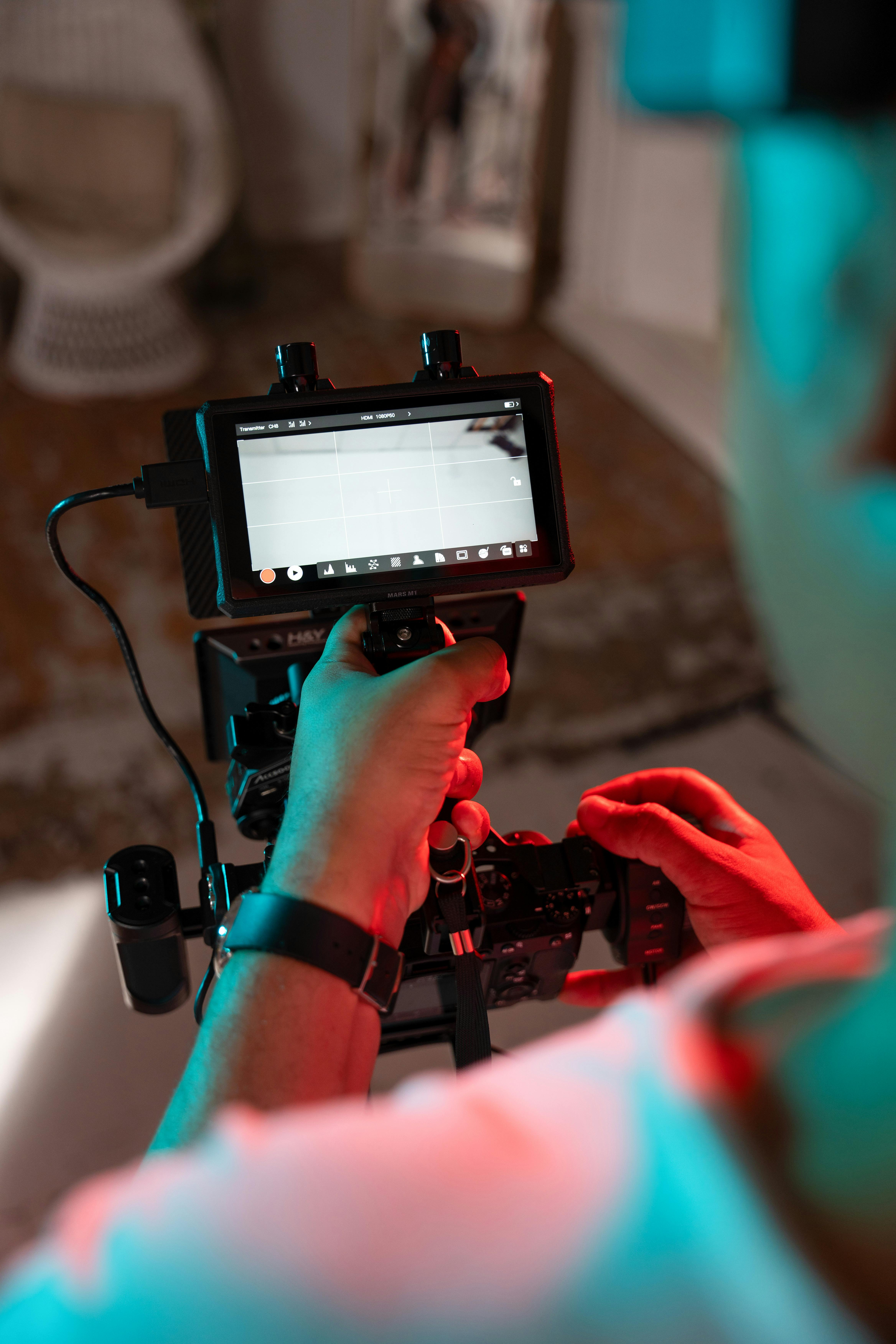 Man Working with Professional Filming Equipment · Free Stock Photo