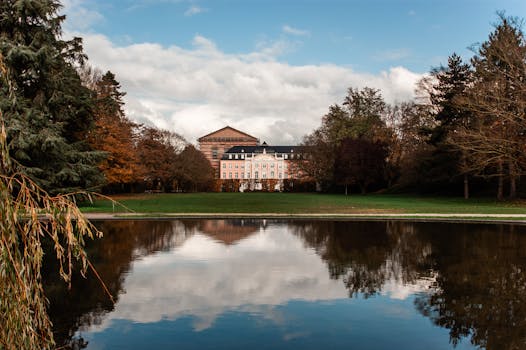 Scenic view of a historic building reflected in a pond at Palastgarten, Trier.