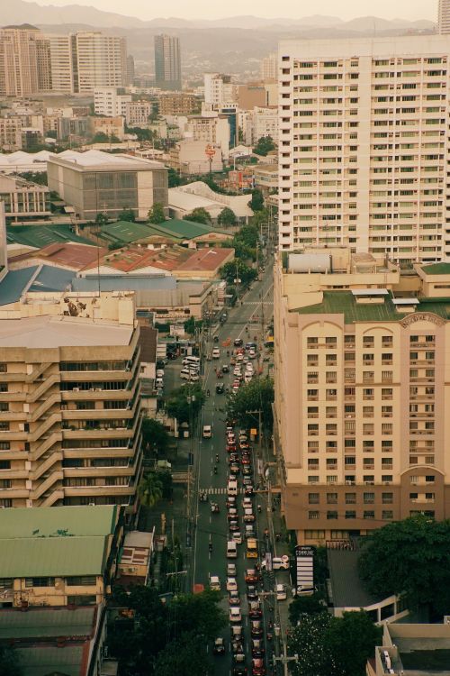 Free High-angle view of busy city street traffic with tall modern buildings. Stock Photo