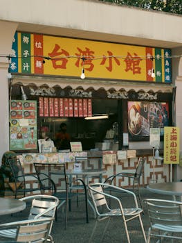 A vibrant Taiwanese street food stall with outdoor seating, perfect for an urban dining experience.