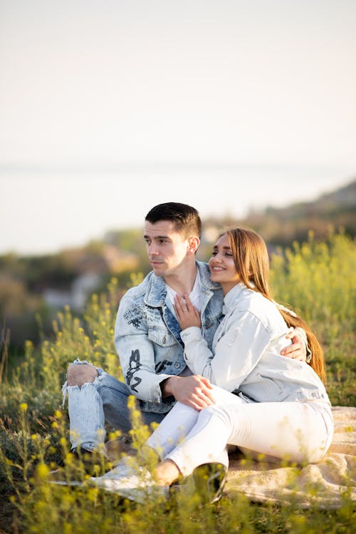 Couple Sitting Together on Meadow