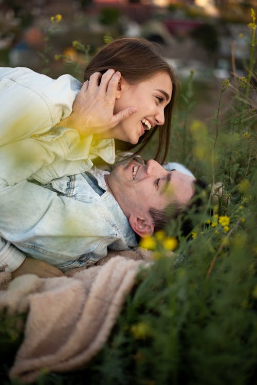 Free Couple Lying Down and Hugging on Meadow Stock Photo
