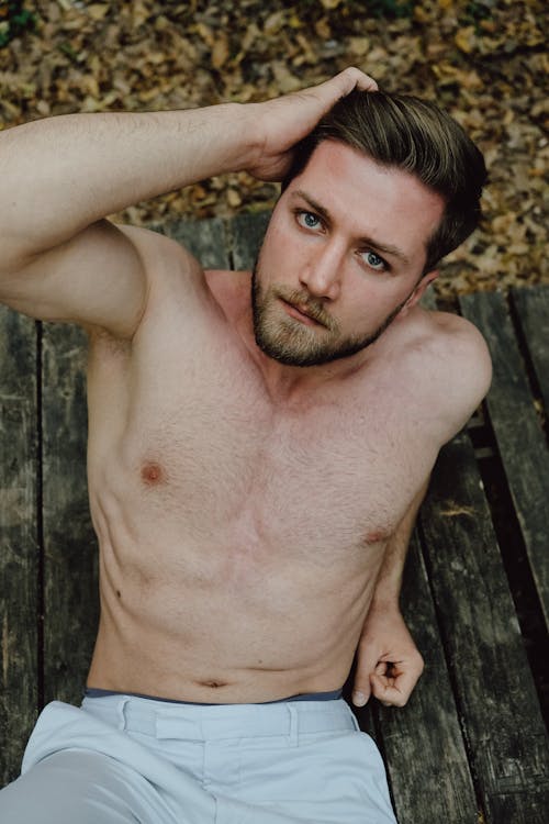 Portrait of a Shirtless Man Sitting Outdoors