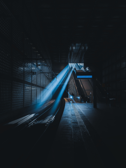 Moody rays making escalators in a Leipzig subway station appear dramatic.