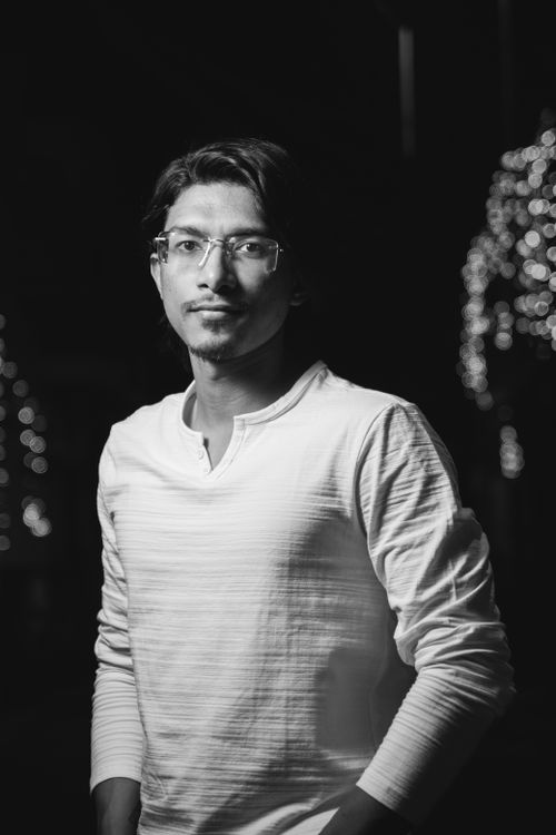 Free Stylish black and white portrait of a man wearing eyeglasses and a sweatshirt. Stock Photo