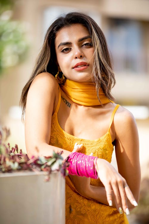 Young Woman in a Yellow Dress Posing Outside 