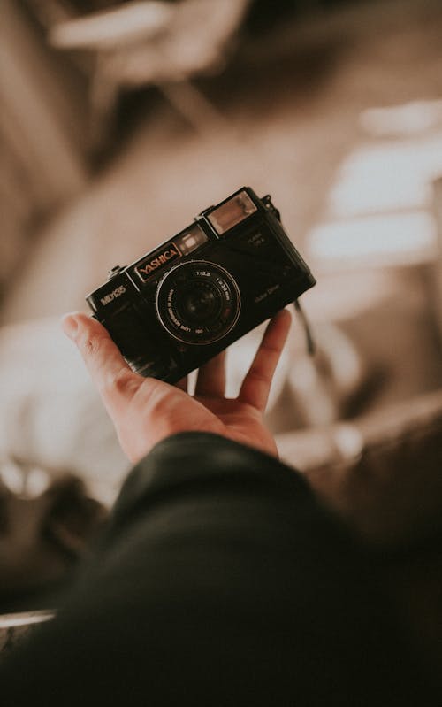 Close-up of a Person Holding a Film Camera 