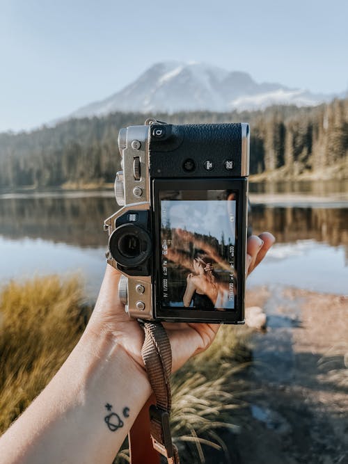 Screen of a Digital Camera While Taking Photos of a Young Woman by the Lake