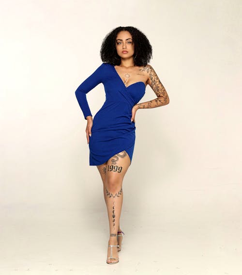 Studio Shoot of a Woman with Tattoos Wearing a Sapphire Dress