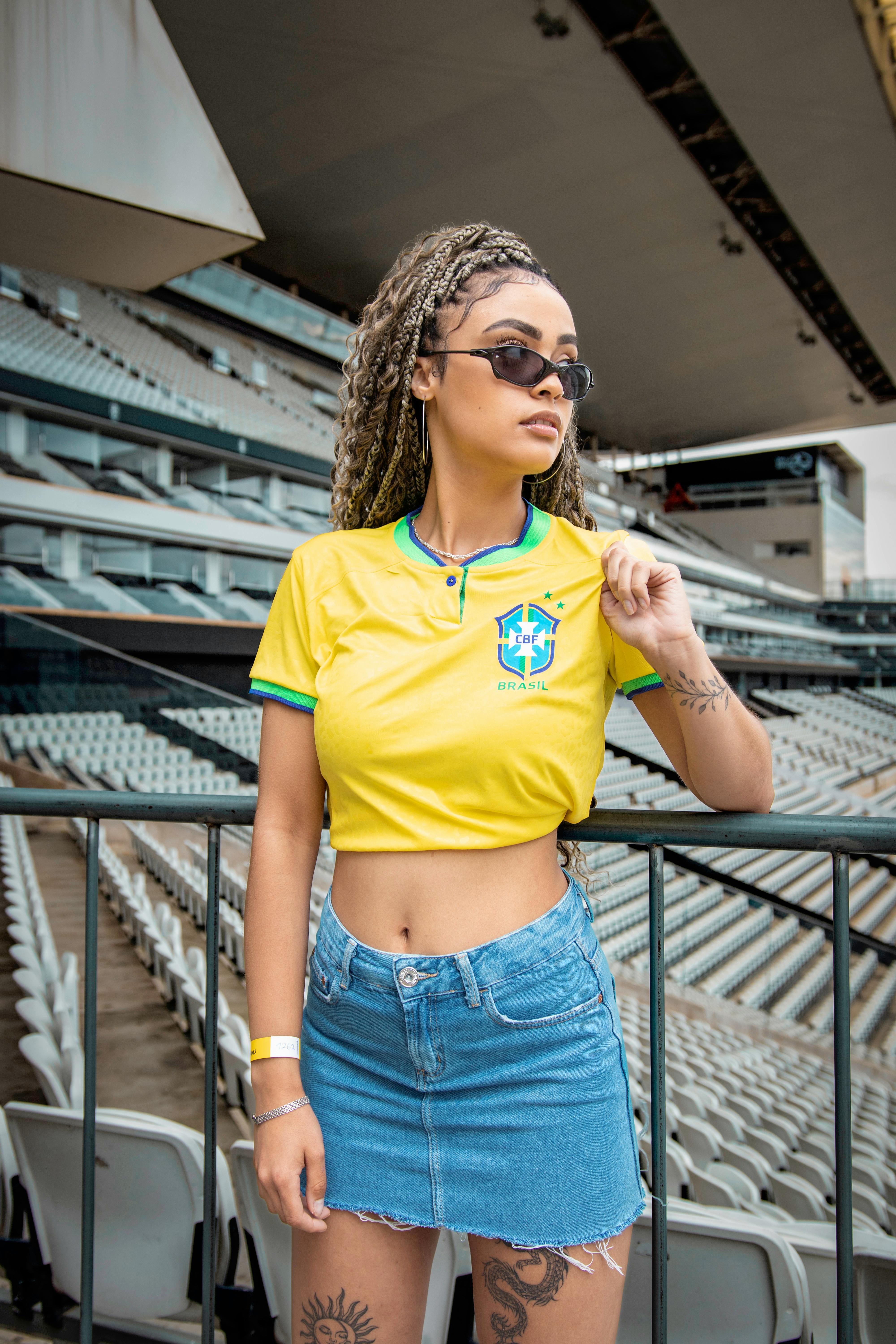 Model in an Unbuttoned Colorful Shirt and Mini Skirt Kneeling on the ...