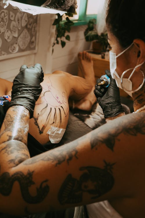 Woman Tattooing on Hip
