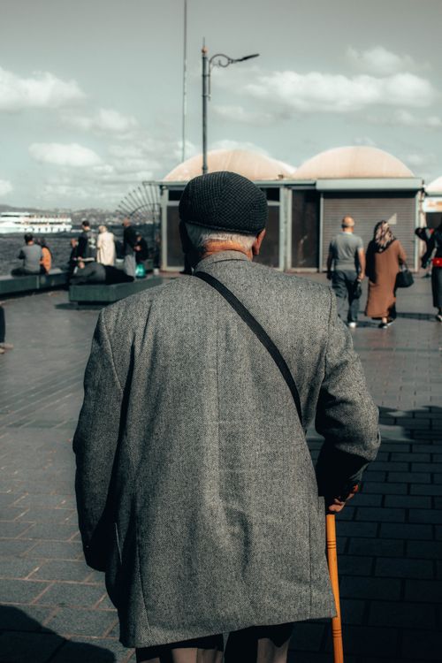 Free Back view of an elderly man with a walking stick on a pier in İstanbul, Türkiye. Stock Photo