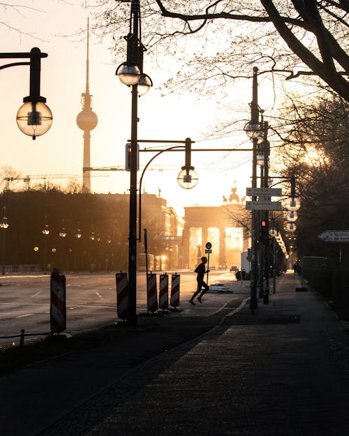 A Person Running on the Streets of Berlin at Dawn 
