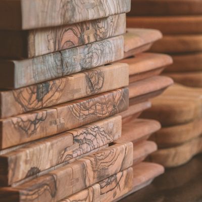 Stacked olivewood serving boards, photo by Razane Adra on Pexels