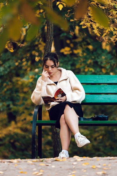 Woman Sitting at Park and Reading