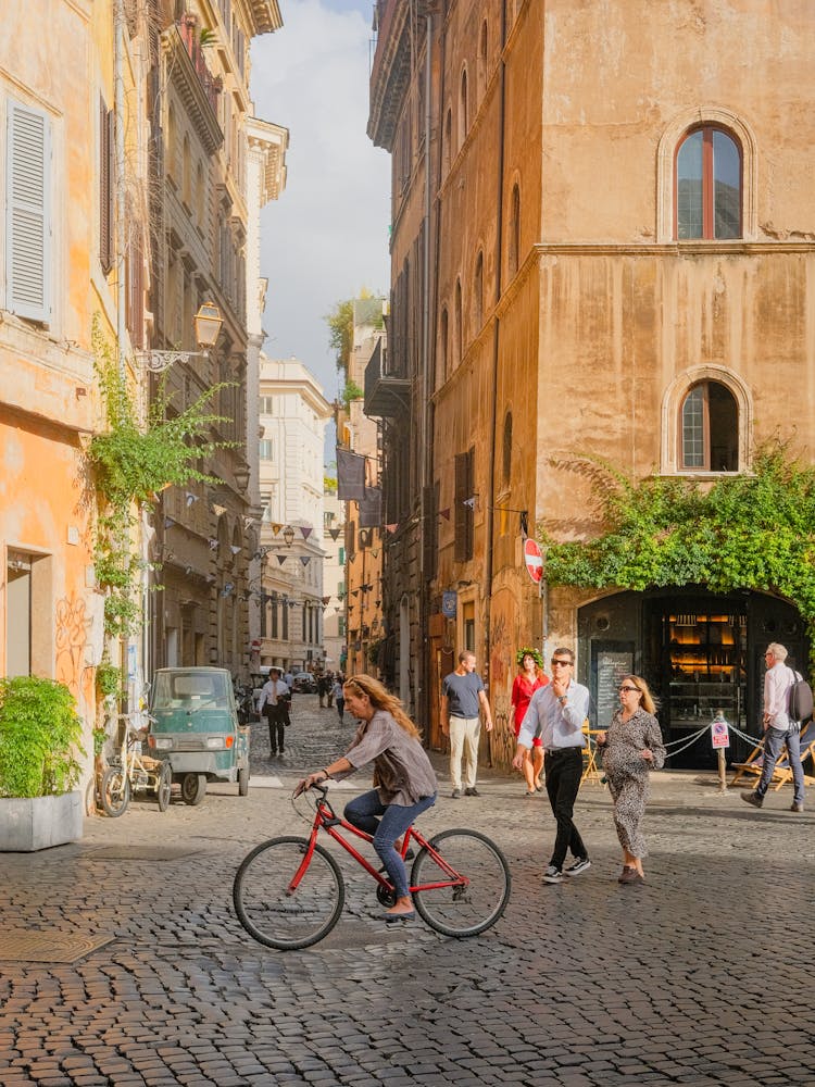 Woman On Bicycle In Old Town