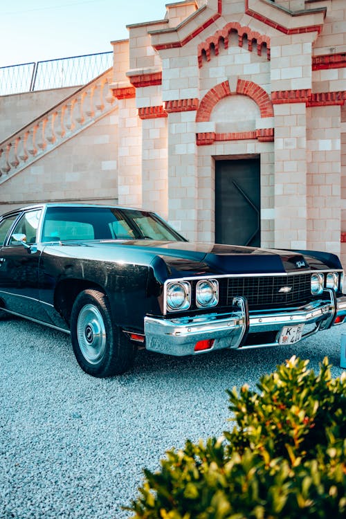 A Vintage Chevrolet Impala in front of a Building 