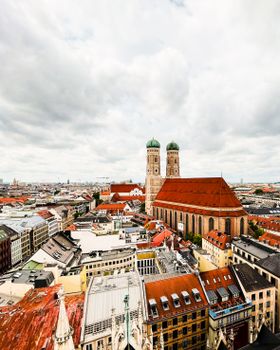 Stunning aerial view of Munich with the iconic Frauenkirche surrounded by urban cityscape.