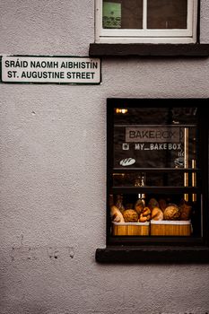 Charming bakery window display with fresh bread on St Augustine Street, Galway.