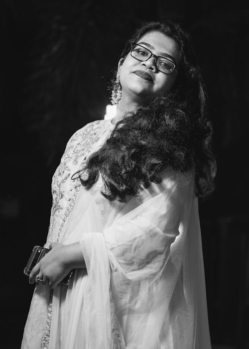 Woman with Long Curly Hair and Eyeglasses in Black and White