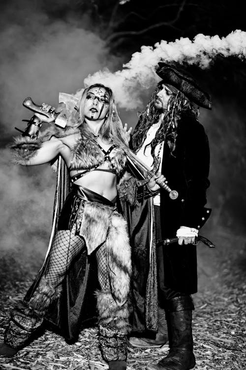 Black and White Photo of a Woman and Man in Halloween Costumes 