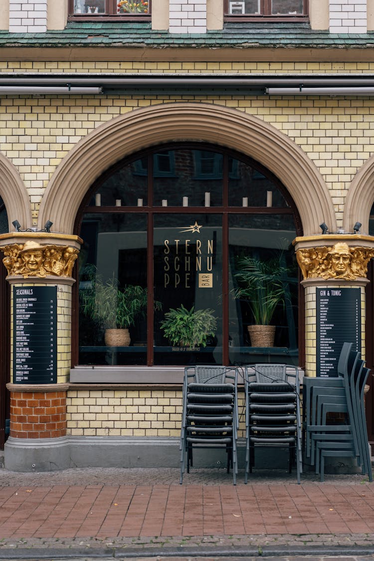 Facade Of A Building With An Arched Window 